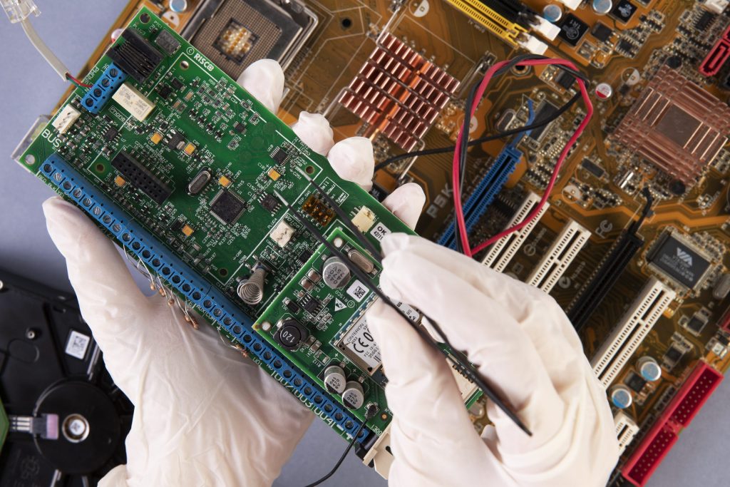 close up hands holding hardware components