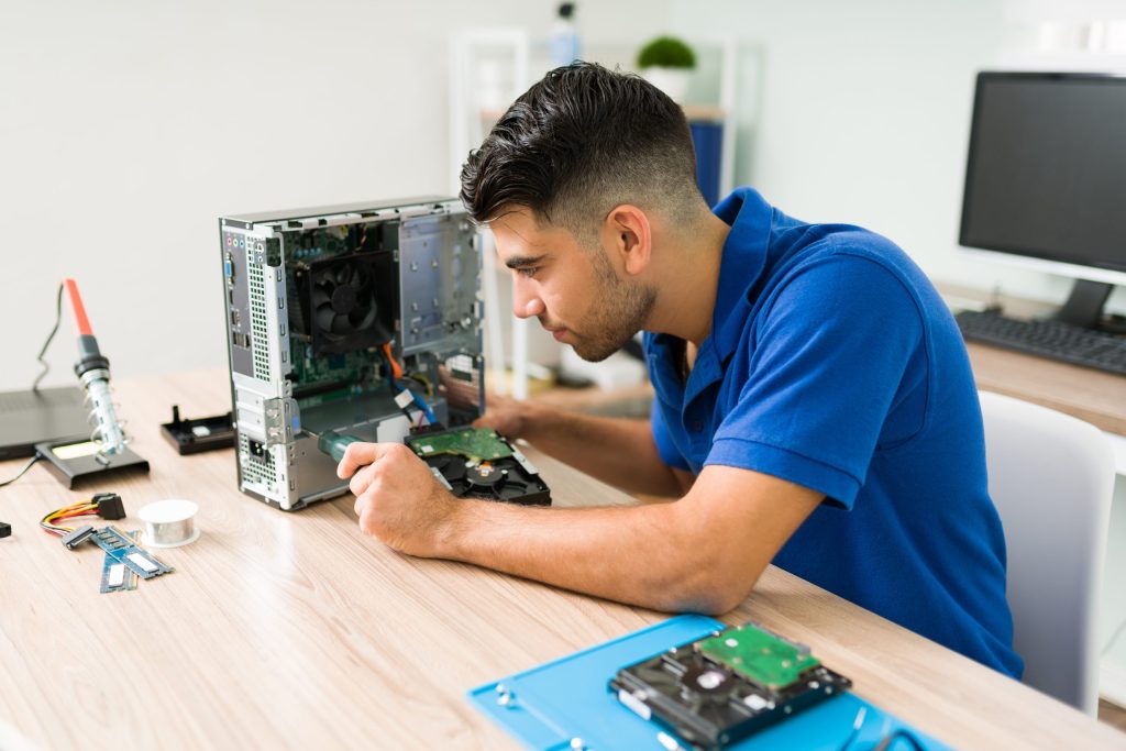 i need fix this young man using screwdriver look inside broken cpu computer before repairing shop
