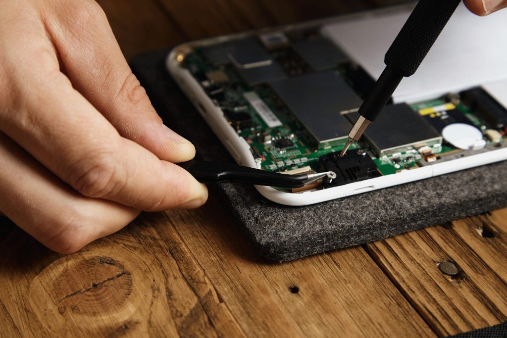 master uses special tools disassemble electronic device carefully pincers bit screw driver