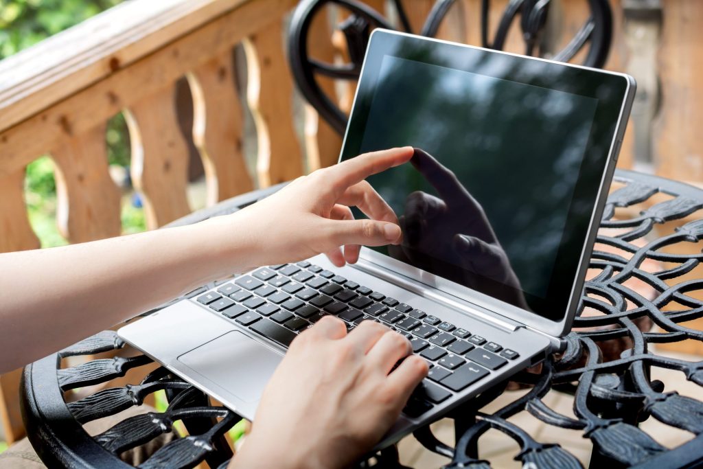 close up person using laptop table