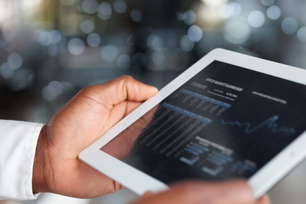 hands tablet screen stock market app investment bokeh background dashboard technology business person with touchscreen finance ui analytics graphs trading fintech