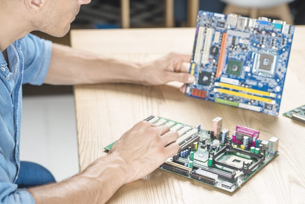 it technician upgrading motherboard wooden table