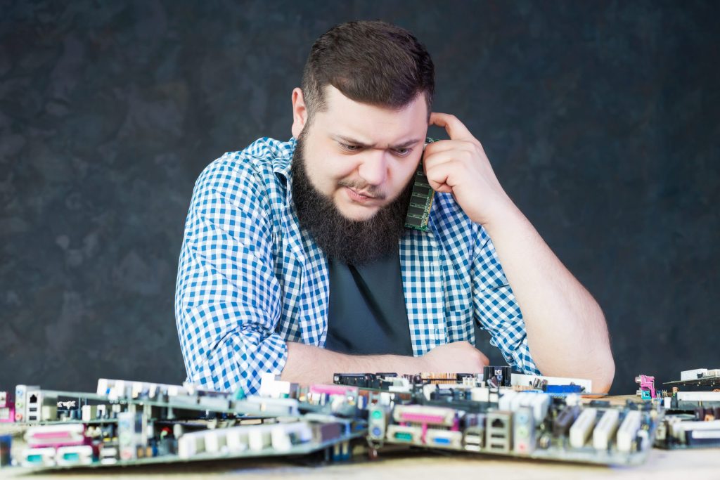 male engineer work with broken computer motherboard electronic devices repairing technology