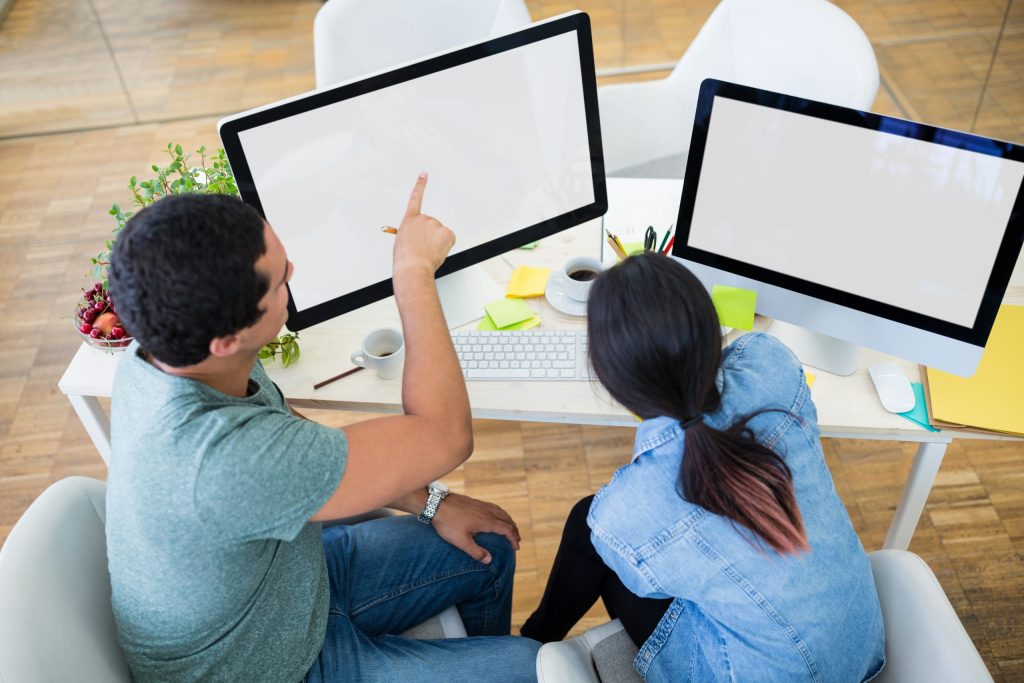 male female graphic designers interacting computer