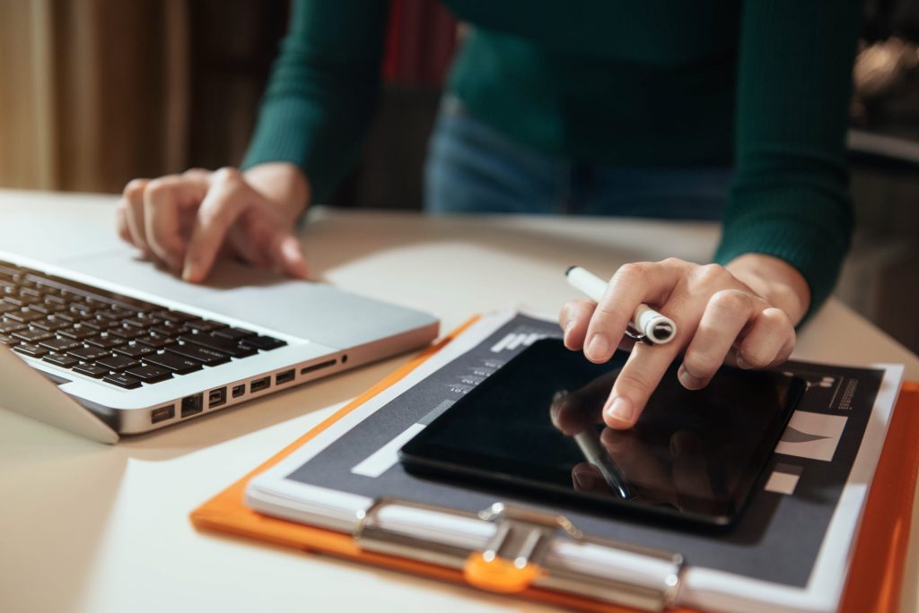 midsection woman using smart phone table