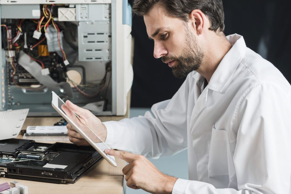side view male technician using digital tablet