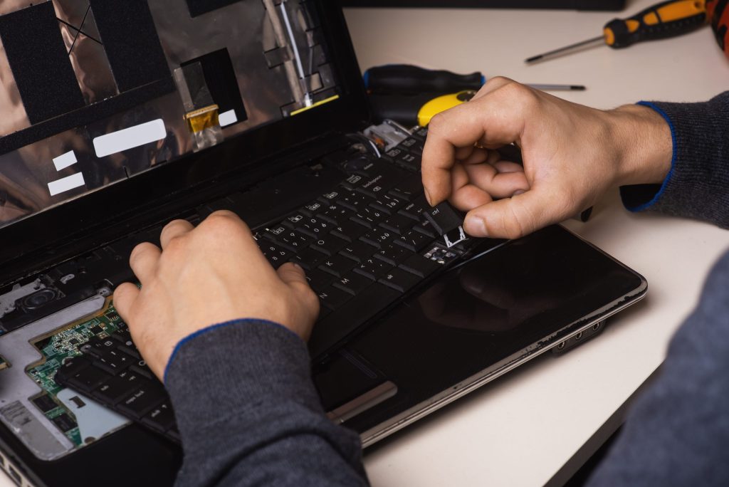 wizard repairs laptop with tools hands